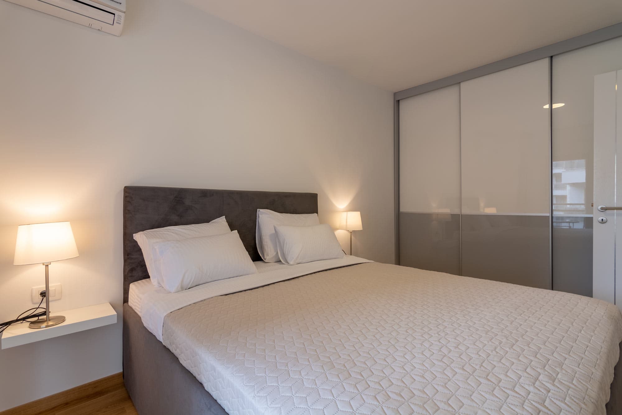 Cozy bedroom with warm lighting in the Cozy Seaside Apartment