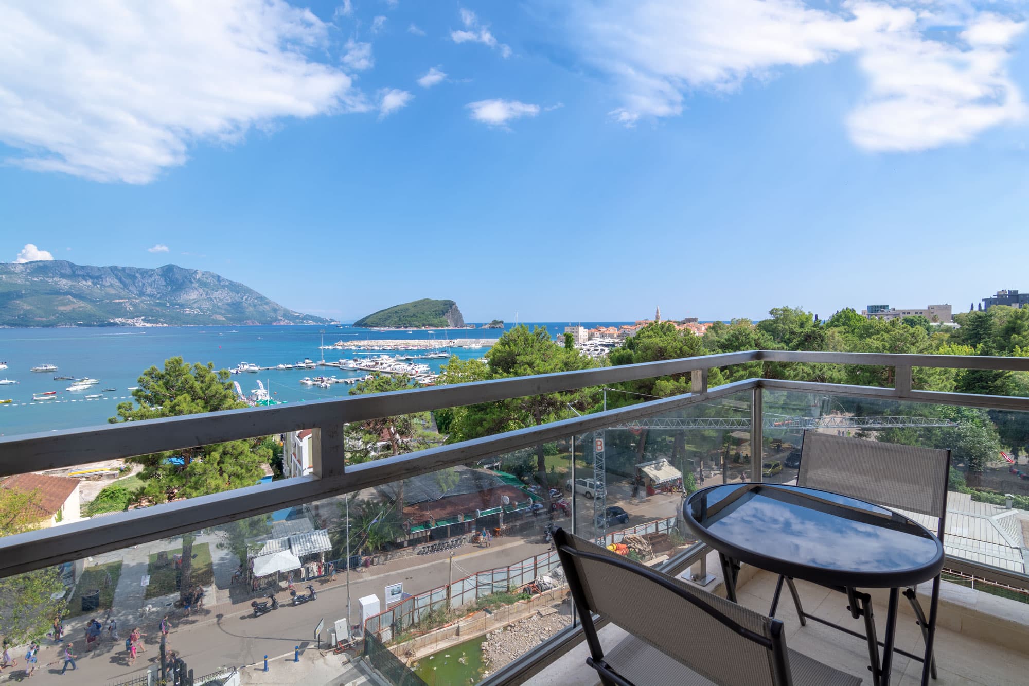 Panoramic sea view from the Seaview Grand balcony — Budva Old Town, marina and Sveti Nikola island